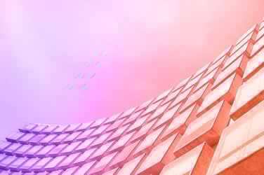 A futuristic building with a sleek design and curved edges.