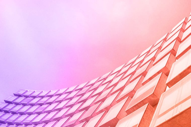 A futuristic building with a sleek design and curved edges.