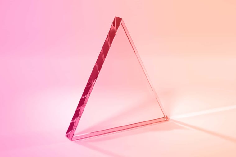 a glass triangle on a gradient background
