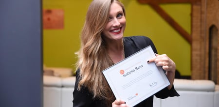 Isabella Benz holding a hubspot sales certification. 