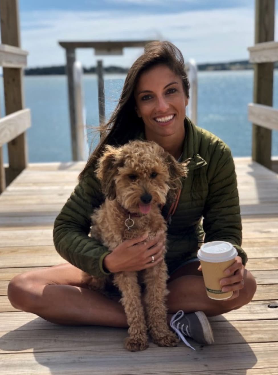 Media Junction team member Deanna on a dock with her dog