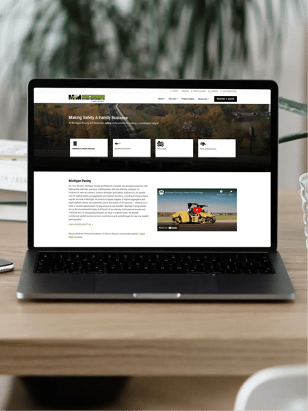 Michican Paving website home page displayed on a laptop