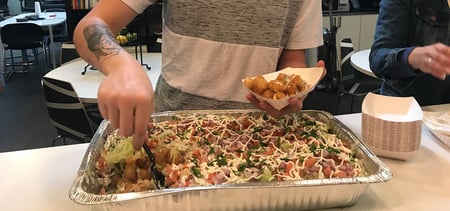 Team member serving themselves totchos. 