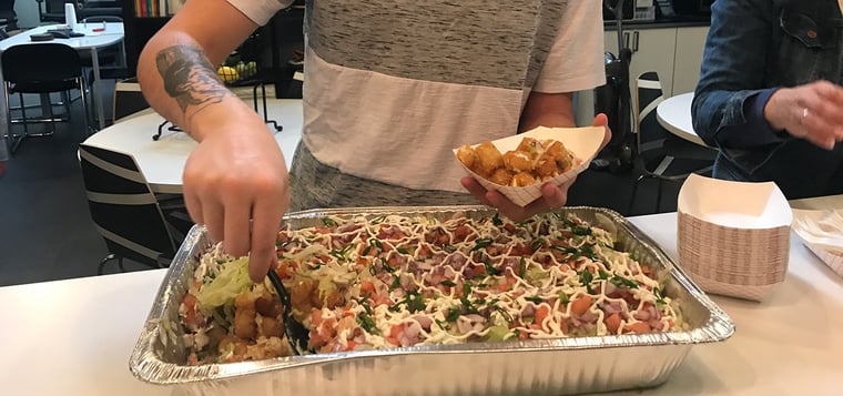 Team member serving themselves totchos. 