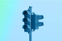 traffic light against a blue gradient background representing compliance and safety