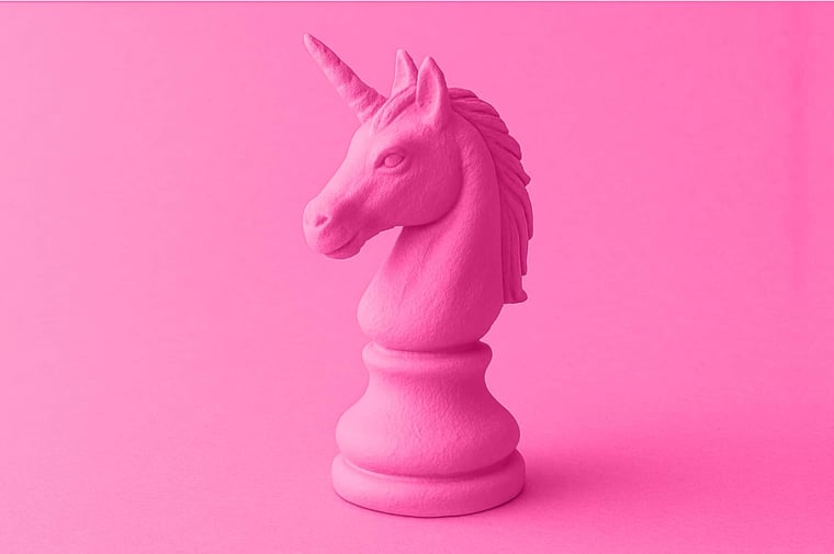 unicorn shaped chess piece on a pink gradient background representing myths
