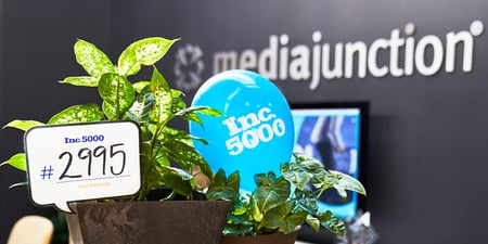 Inc 5000 logo on blue balloon in media junction office. 