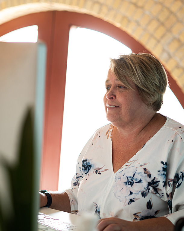 Kim Wilcox working at her desk