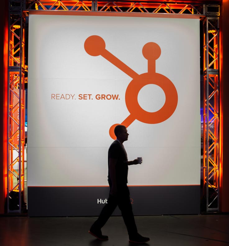 HubSpot photo from Inbound conference of man walking past the sign that says: Ready set grow. 